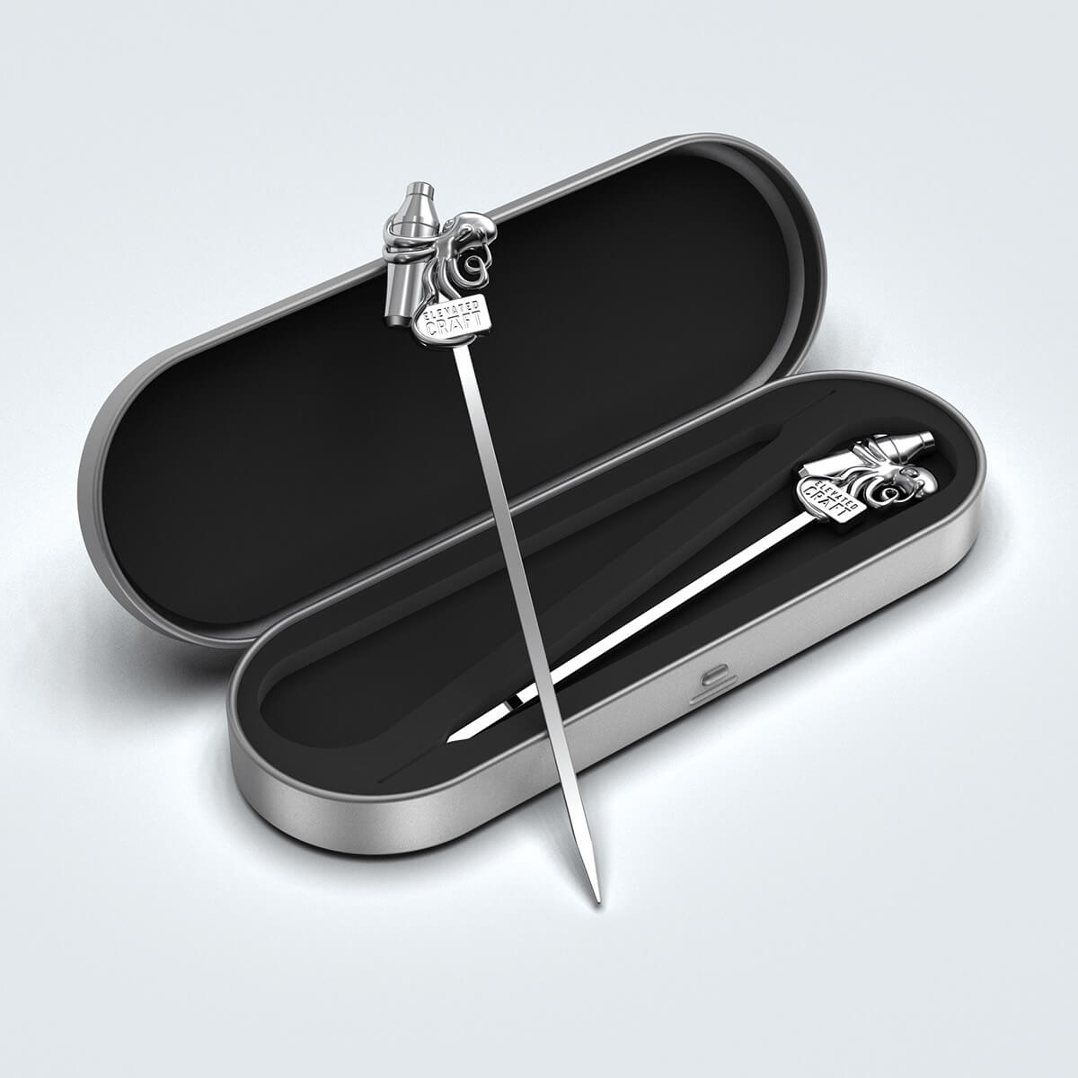 cocktail pick leaning on its tin case with a second cocktail pick inside the case. The top of the pick has an octopus holding a cocktail shaker on it.