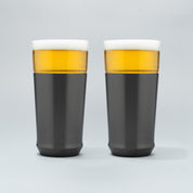 Two Elevated Craft hybrid pint glasses in gunmetal black finish full of cold beer