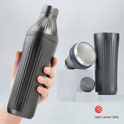 Hand holding a Gunmetal Black Diamond Edition Hybrid Cocktail Shaker with another image of the shaker taken apart to show the parts separate on gray background with RedDot Winner 2025 logo overlay