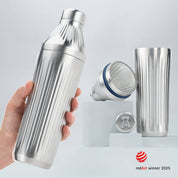 Hand holding a Stainless Steel Diamond Edition Hybrid Cocktail Shaker with another image of the shaker taken apart to show the parts separate on gray background with RedDot Winner 2025 logo overlay