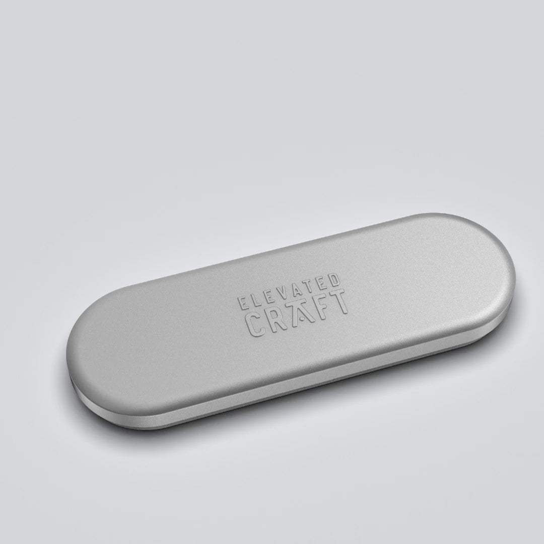 video on grey background of tin cocktail pick case opening to reveal two Elevated Craft cocktail picks inside.