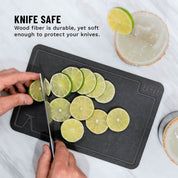 Photo of cut limes on a white marble counter using the elevated craft wood fiber garnish board