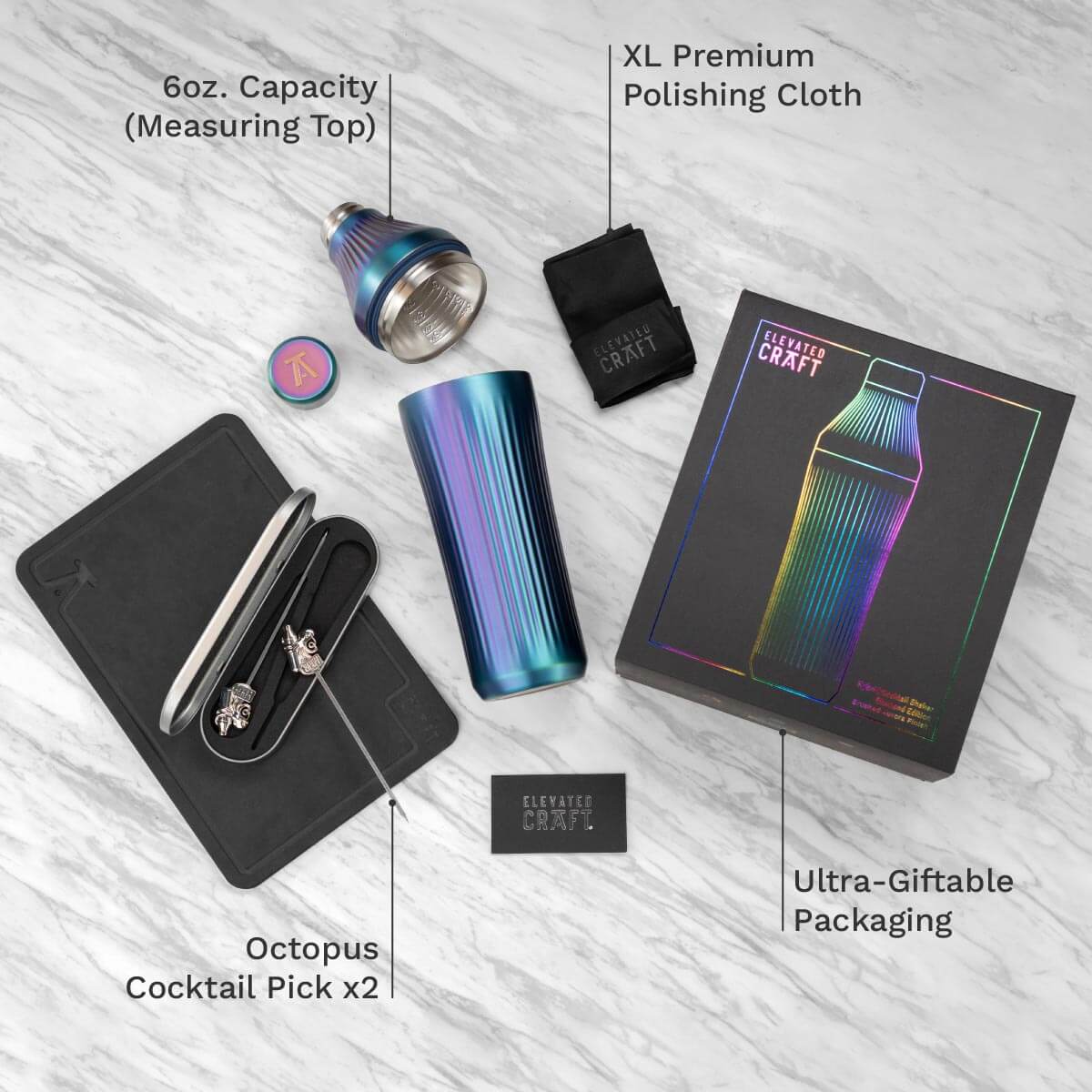 Cocktail shaker set with accessories on a light gray surface