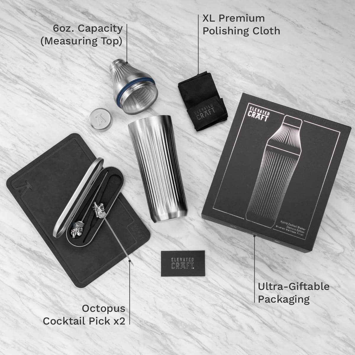 Cocktail shaker set with accessories on a light wooden surface