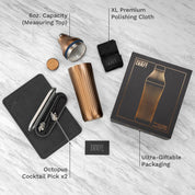 Cocktail shaker set with packaging on a light wooden surface