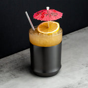 Elevated Craft Gunmetal Black Hybrid Cocktail Glass with orange cocktail topped with orange slice and red drink umbrella