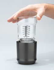 Hand holding the glass insert of the Gunmetal Black Hybrid Cocktail Class