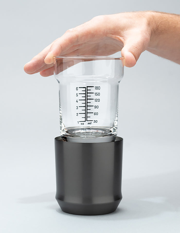 Hand holding the glass insert of the Gunmetal Black Hybrid Cocktail Class