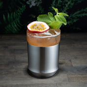 Elevated Craft Brushed Stainless Hybrid Cocktail Glass filled with orange colored cocktail topped with a passionfruit and mint