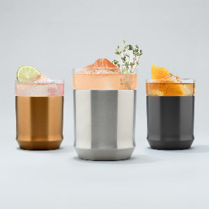 Three Hybrid Cocktail Glass on grey background with cocktails inside