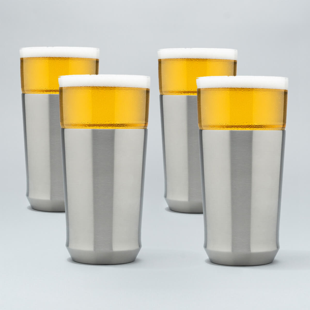 Four Elevated Craft Hybrid Pint Glasses in brushed stainless finish filled with cold beer to the top of their rims