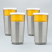 Four Elevated Craft Hybrid Pint Glasses in brushed stainless finish filled with cold beer to the top of their rims