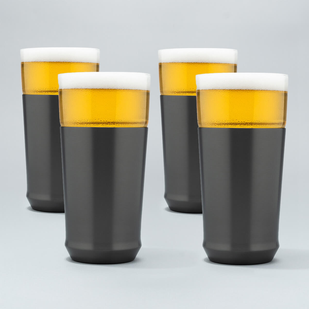 Four Elevated Craft gunmetal black hybrid pint glasses filled with cold beer