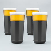Four Elevated Craft gunmetal black hybrid pint glasses filled with cold beer