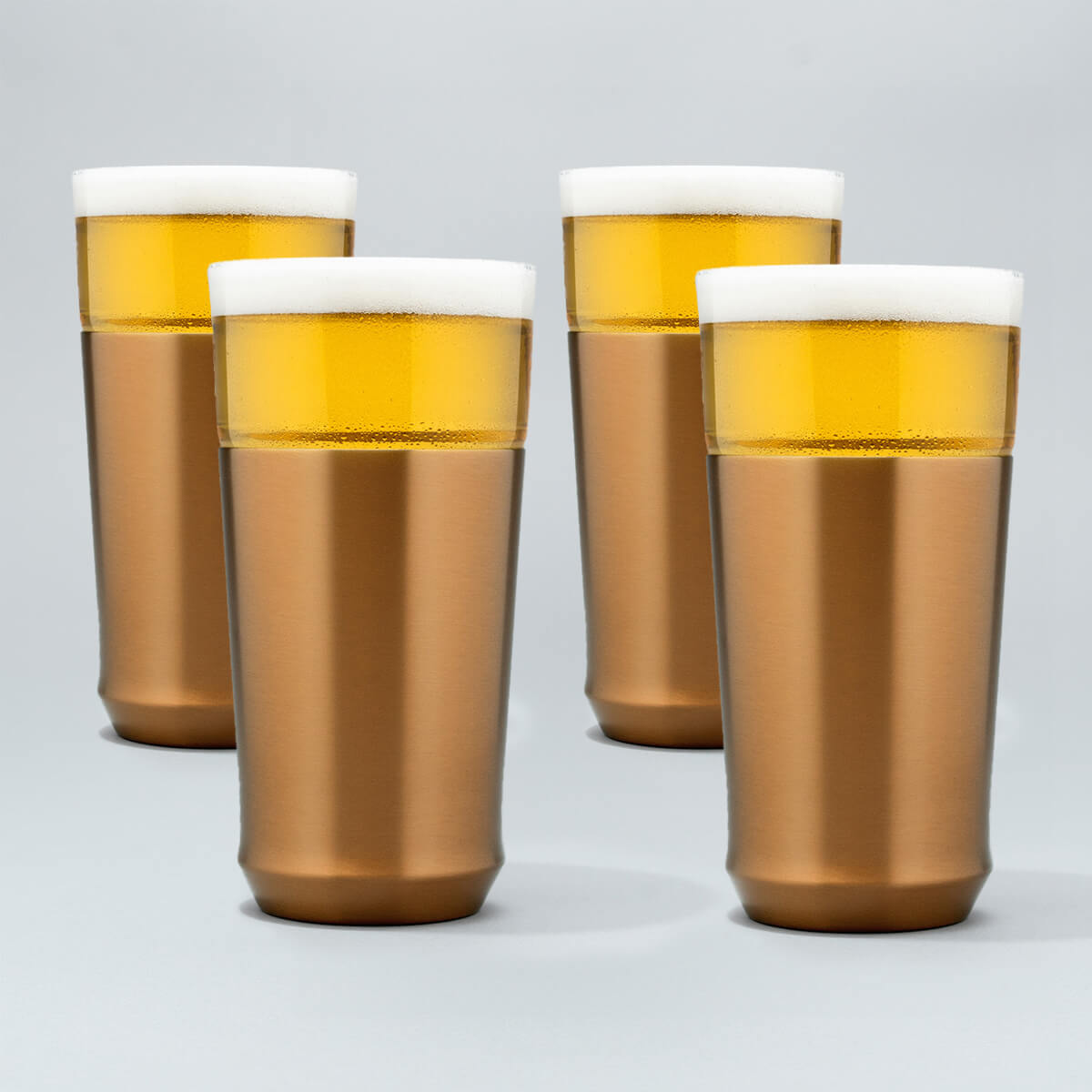 Four Elevated Craft brushed copper hybrid pint glasses filled with cold beer