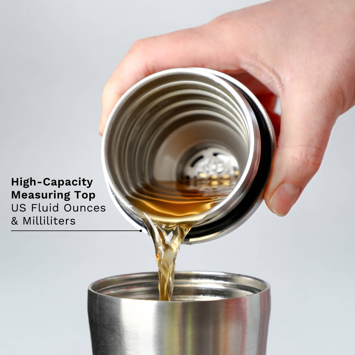 Hand pouring Stainless Steel Elevated Craft Hybrid Cocktail Shaker Measuring Top into tumbler