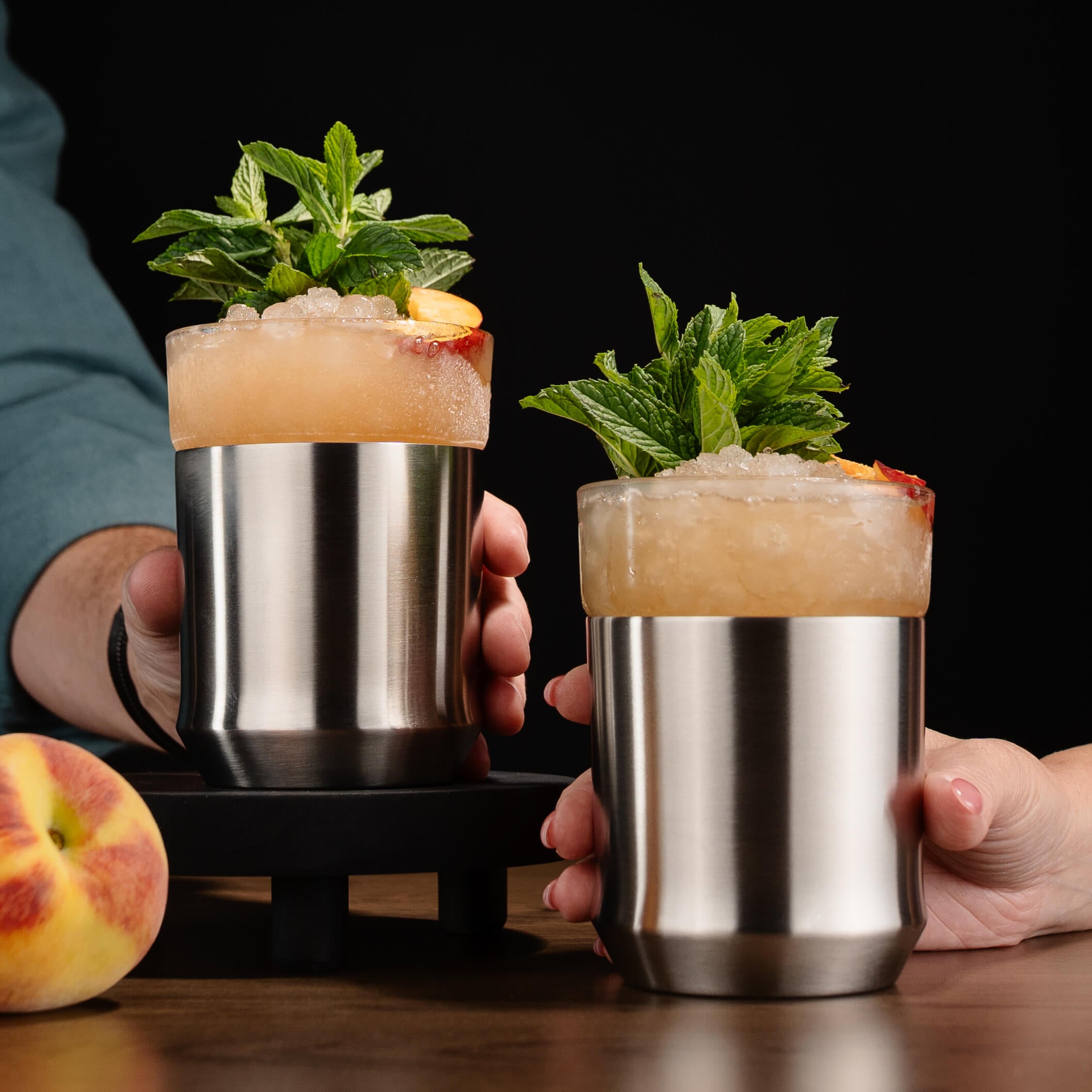 Two Elevated Craft Hybrid Rocks Glasses with a Peach Julep cocktail in it 