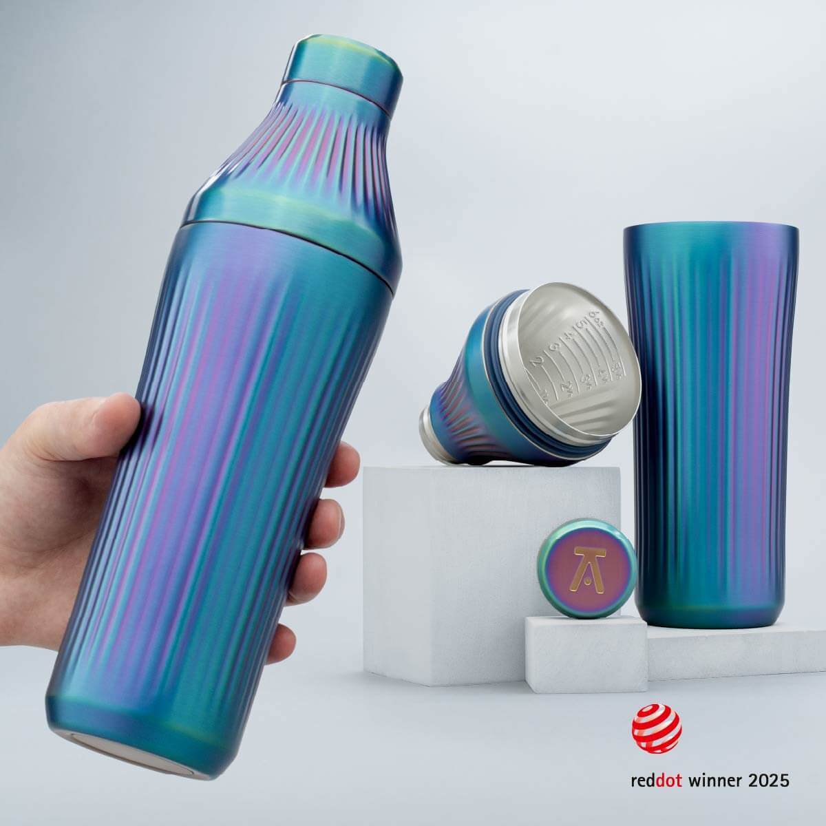 Blue and purple striped water bottle held by a hand with additional bottles on a light gray background.