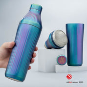 Blue and purple striped water bottle held by a hand with additional bottles on a light gray background.