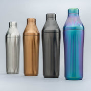 Four metallic water bottles of different colors on a light gray background