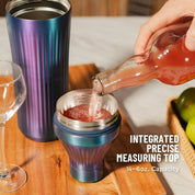 Person pouring a drink into a colorful measuring cup with text 'Integrated Precise Measuring Top' on a wooden surface.