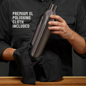 Man in dark grey button down shirt holding the Brushed Stainless Elevated Craft Diamond Edition Hybrid Cocktail Shaker being polished with a Premium XL Polishing Cloth with callout saying Polishing Cloth is included