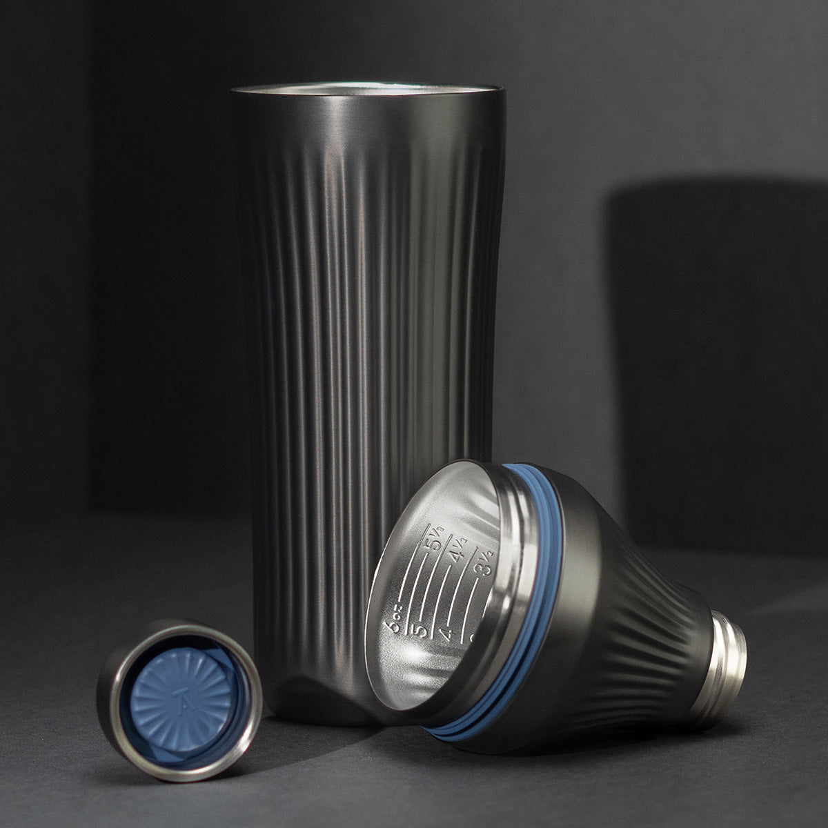 Gunmetal Black Elevated Craft Diamond Edition Hybrid Cocktail Shaker split up into parts showcasing tumbler, measuring top and lid