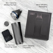 Elevated Craft product set with tumbler, measuring top, polishing cloth, and packaging on a light wooden surface.