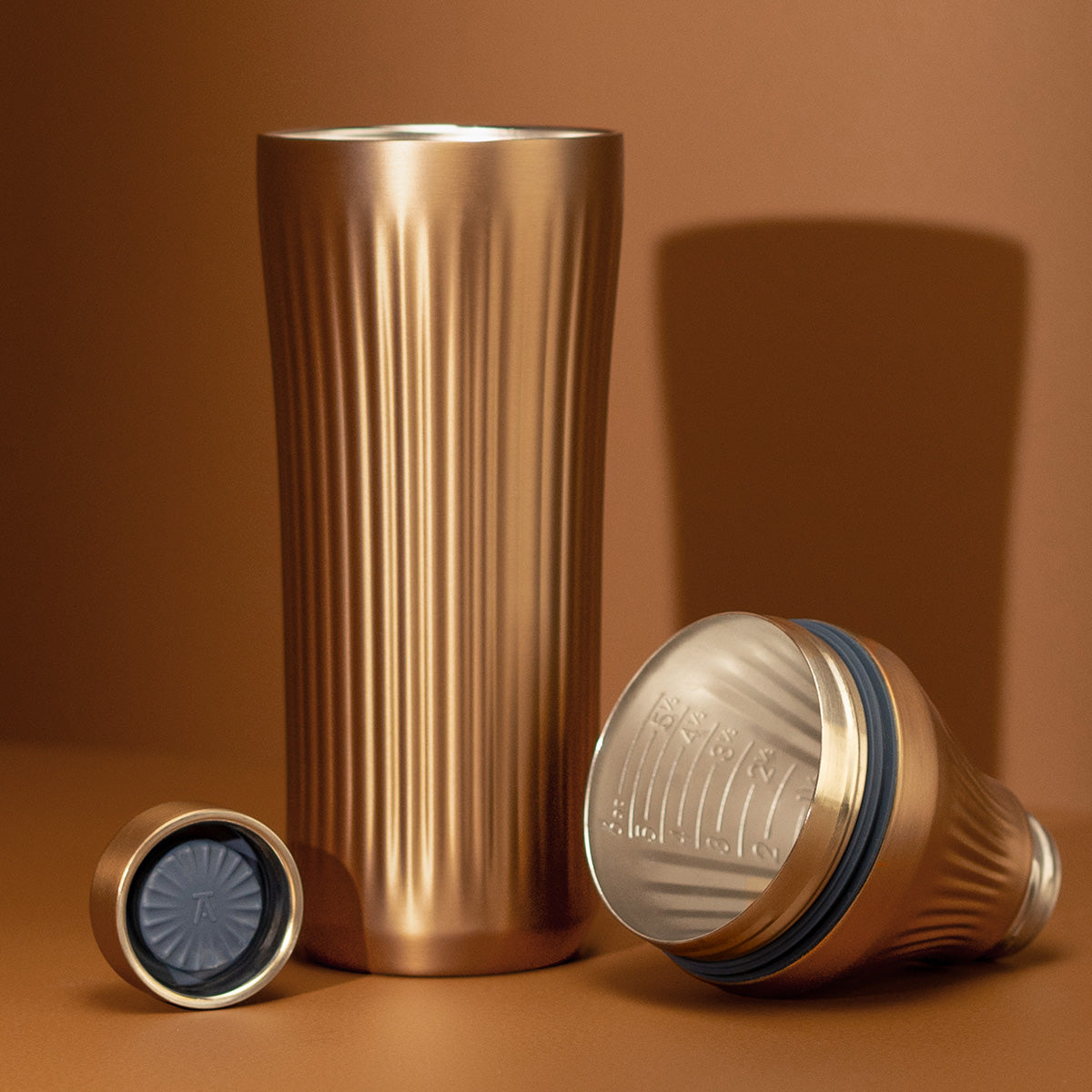Brushed Copper Elevated Craft Diamond Edition Hybrid Cocktail Shaker split up into parts showcasing tumbler, measuring top and lid