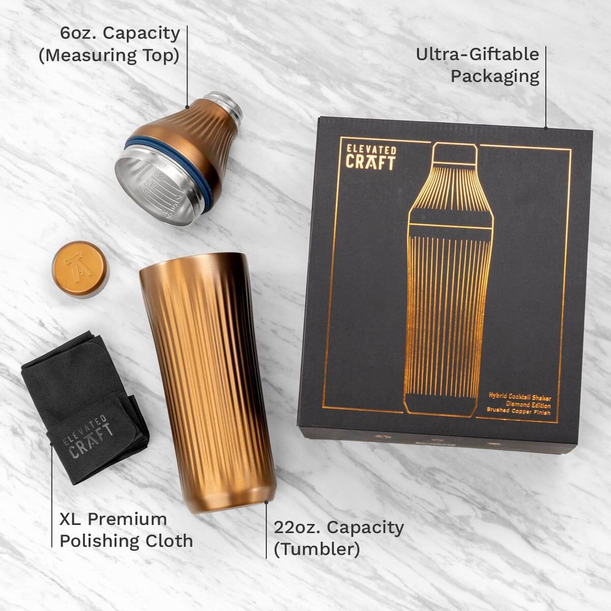Cocktail shaker set with packaging, measuring top, tumbler, and polishing cloth on a white background.