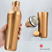 Hand holding a Brushed Copper Diamond Edition Hybrid Cocktail Shaker with another image of the shaker taken apart to show the parts separate on gray background with RedDot Winner 2025 logo overlay