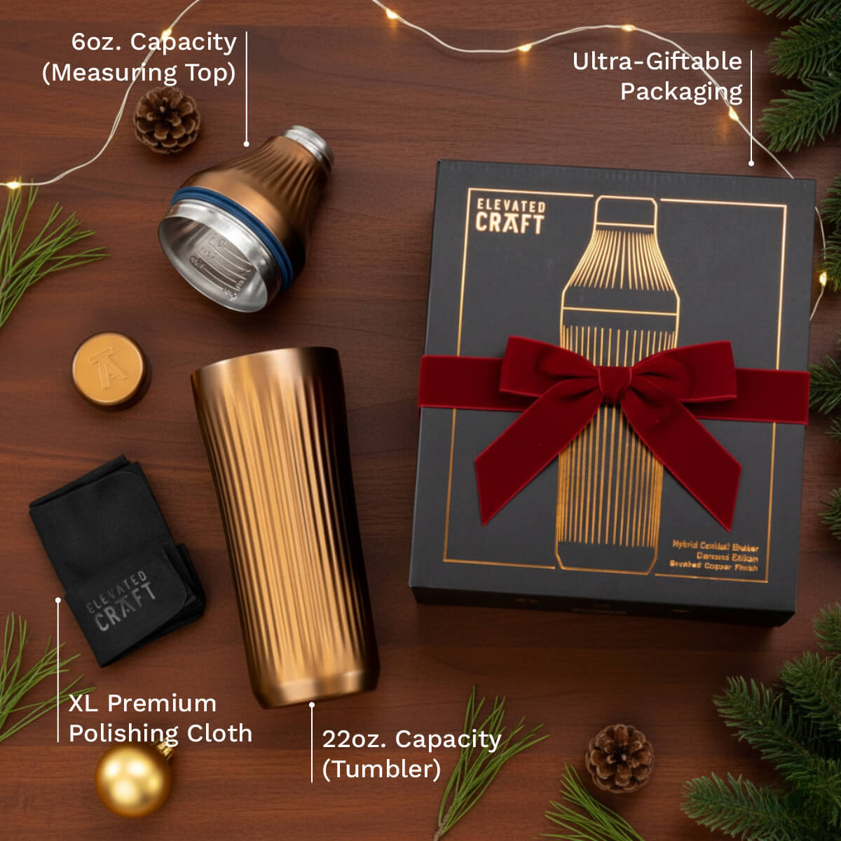 Elevated Craft drinkware set with tumbler, measuring top, polishing cloth, and gift box on a wooden surface.