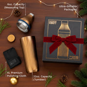 Elevated Craft drinkware set with tumbler, measuring top, polishing cloth, and gift box on a wooden surface.