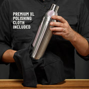 Man in dark grey button down shirt holding the Brushed Stainless Elevated Craft Diamond Edition Hybrid Cocktail Shaker being polished with a Premium XL Polishing Cloth with callout saying Polishing Cloth is included