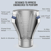 Stainless steel measuring cup with labeled features on a gray background