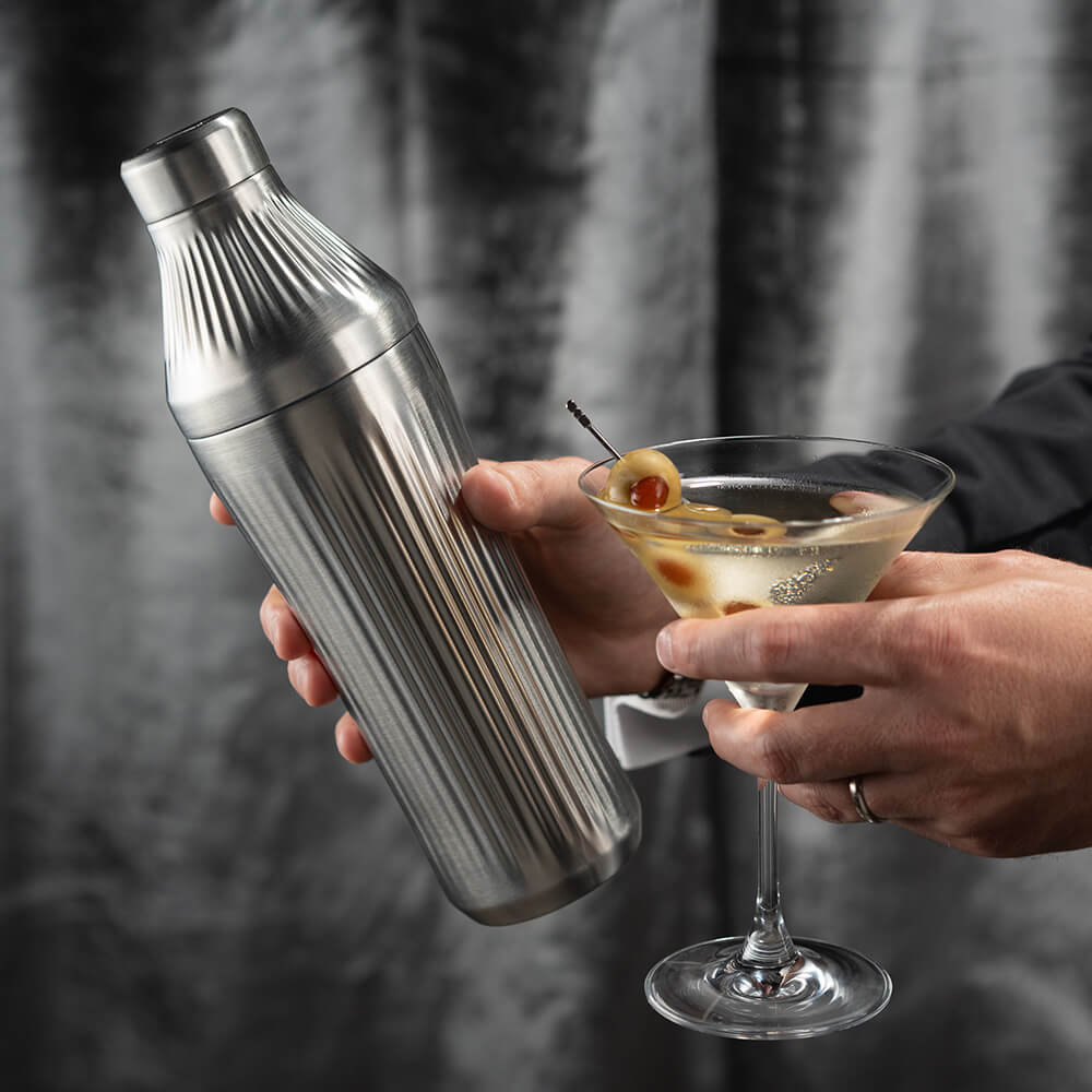 Hands holding dirty martini glass and the Stainless Steel Elevated Craft Diamond Edition Hybrid Cocktail Shaker