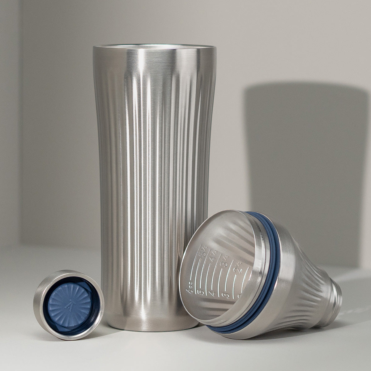 Stainless Steel Elevated Craft Diamond Edition Hybrid Cocktail Shaker split up into parts showcasing tumbler, measuring top and lid
