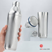 Hand holding a Stainless Steel Diamond Edition Hybrid Cocktail Shaker with another image of the shaker taken apart to show the parts separate on gray background with RedDot Winner 2025 logo overlay