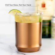 Hybrid Cocktail Glass in brushed copper finish filled with bright yellow cocktail garnished with lime wheel garnish