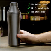 Hand holding Gunmetal Black Elevated Craft Hybrid Cocktail Shaker on bar top