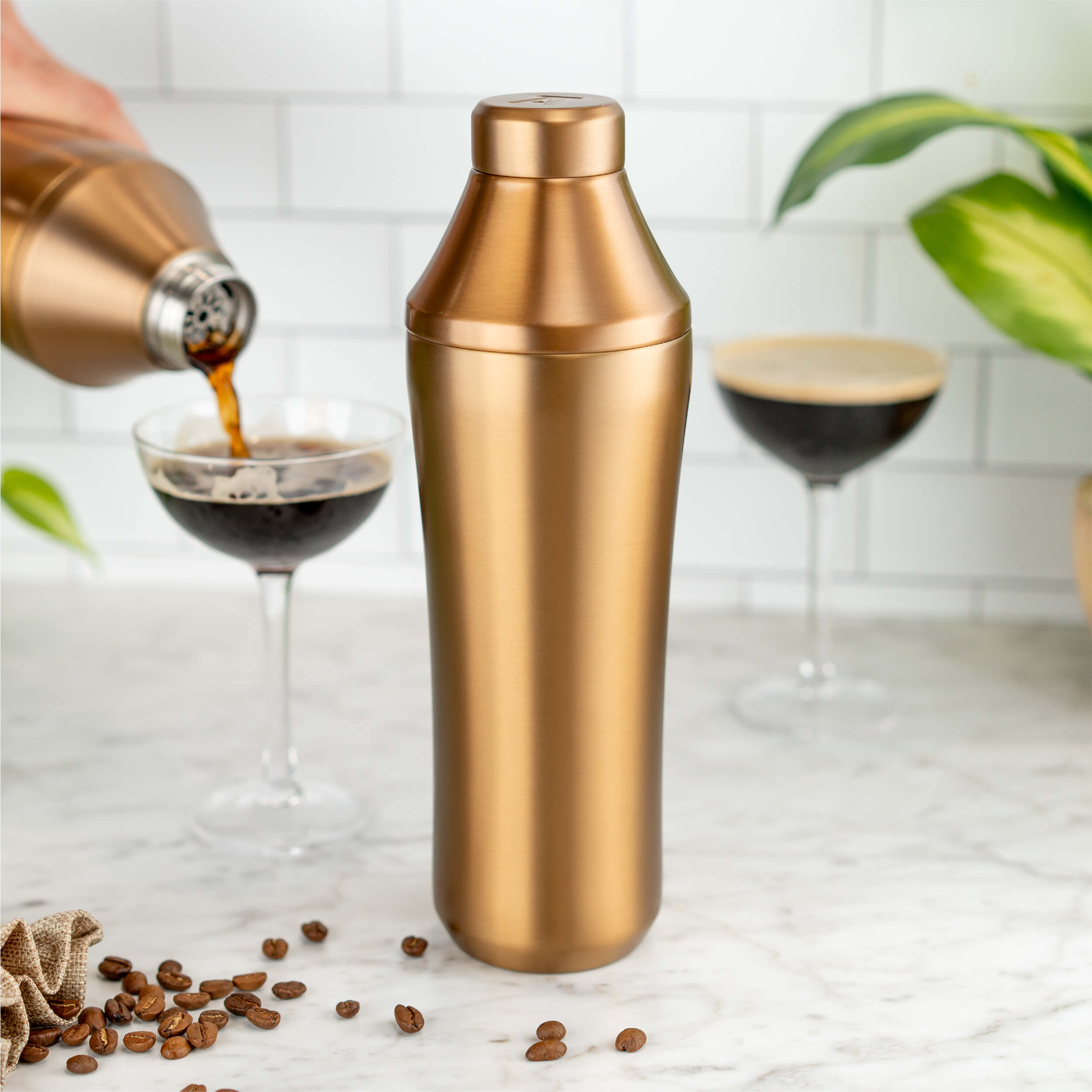 Brushed Copper Elevated Craft Hybrid Cocktail Shaker with hand pouring espresso martini into glass