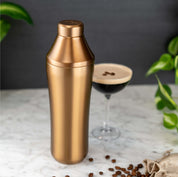 Brushed Copper Elevated Craft Hybrid Cocktail Shaker next to espresso martini with foam and espresso beans on top