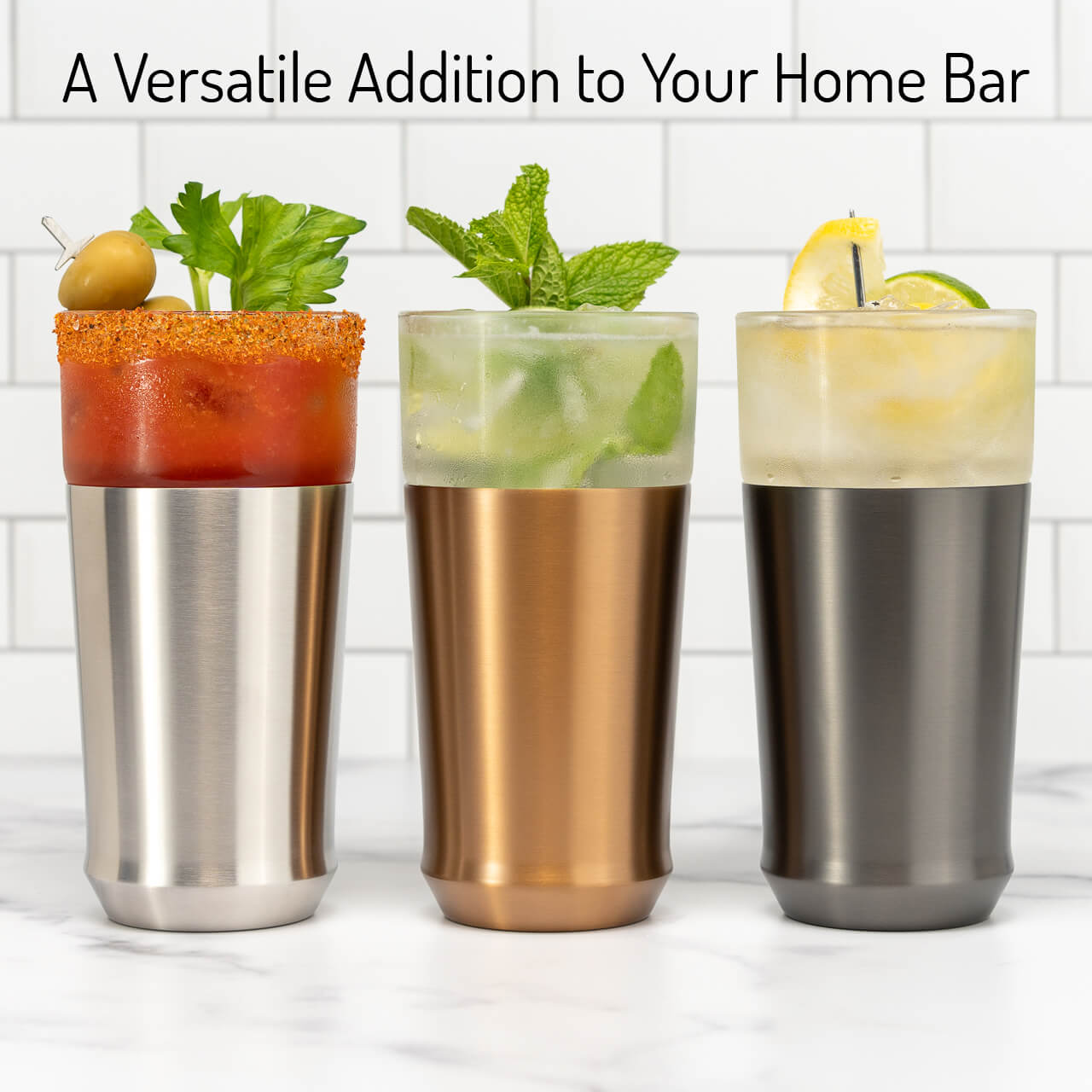 An Elevated Craft Hybrid Pint Glass in the brushed stainless finish filled with a bloody mary next to a brushed copper finish hybrid pint glass filled with a mojito next to a gunmetal black finish hybrid pint glass filled with a citrus cocktail garnished with a lemon and lime wheel