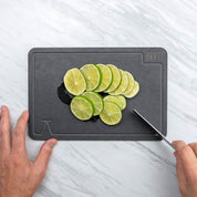 Video of cutting limes on a white marble counter using the elevated craft cutting board