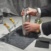 Gif-style video of man in suit using the Stainless Steel Elevated Craft Diamond Edition Hybrid Cocktail Shaker to make a classic dirty martini